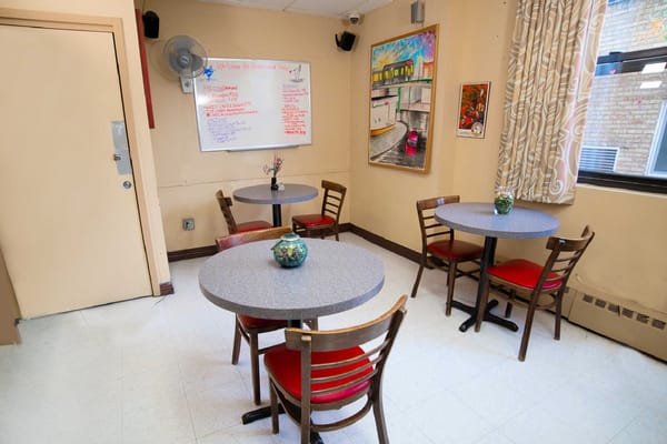 Common area with tables and chairs in a facility