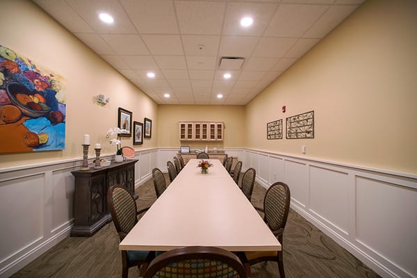 Bright common area with long table and chairs