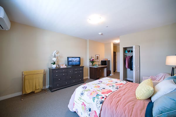 Cozy resident room featuring a bed and TV