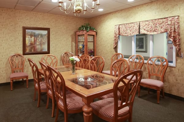 Cozy dining room with wooden furniture and a floral wall design