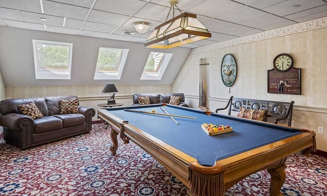 Activity room with a pool table and cozy seating
