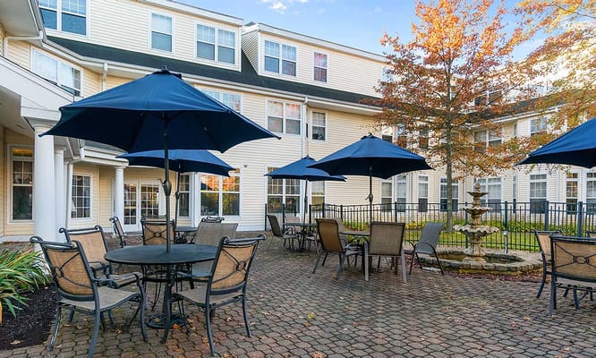 Outdoor seating area with umbrellas and a fountain