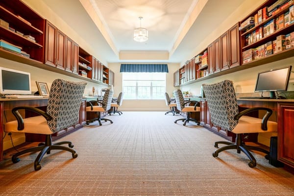 Interior view of a cozy activity room with desks and computers