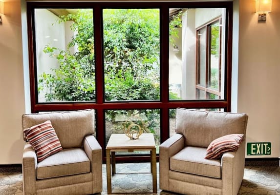 Cozy seating area with natural light and garden view
