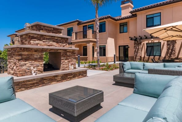 Outdoor lounge area with seating and a fireplace