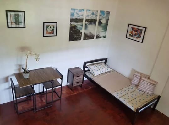 A small private resident room with a bed and table