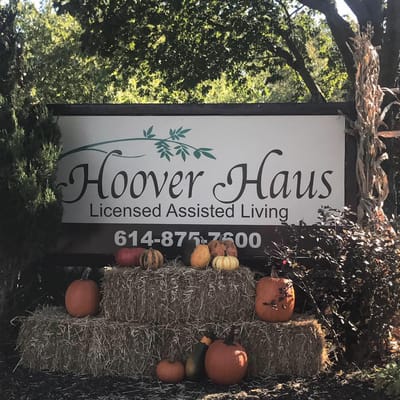 Sign for Hoover Haus with pumpkins in autumn decor