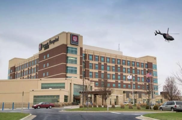 Exterior view of IU Health Arnett Hospital with helicopter