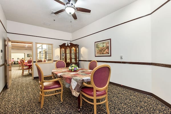 Interior view of a dining room setup with table and chairs