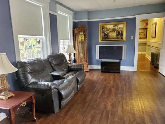 Cozy lounge area with seating and wall artwork