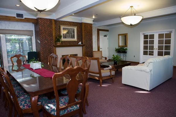 Interior view of a living room with a dining table and seating areas