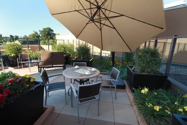Outdoor patio area with seating and flowers