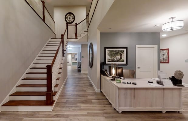 Modern reception area with staircase and desk