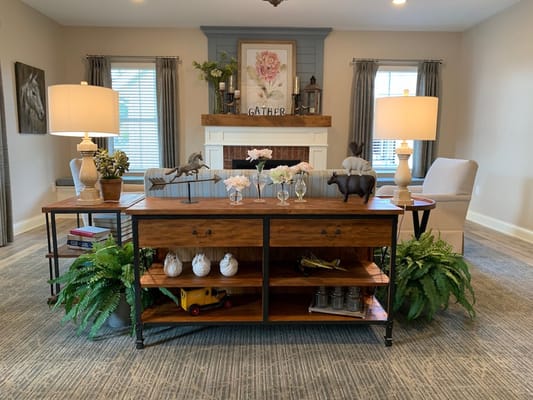 Cozy common area with a wooden table, lamps, and decor
