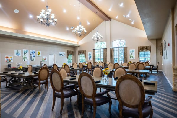Bright dining room with elegant furnishings and flower centerpieces