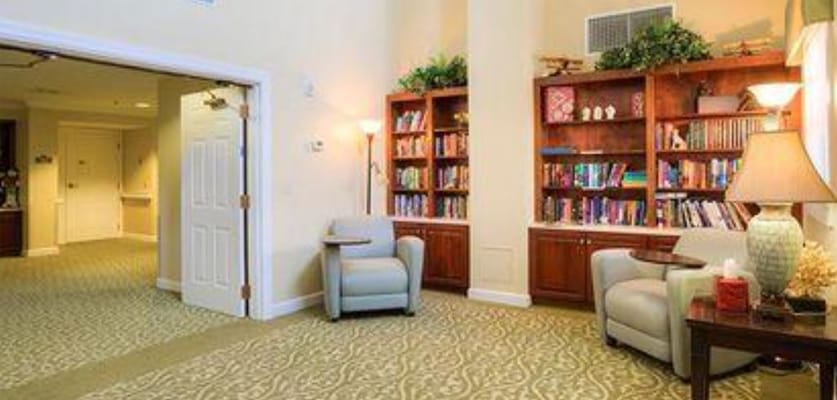A cozy seating area with bookshelves at Langit Assisted Living Facility.
