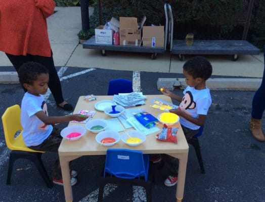 Two children engaged in an art activity outdoors