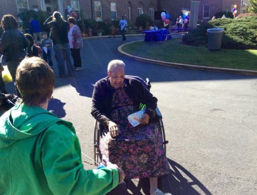 A resident in a wheelchair enjoying an outdoor event