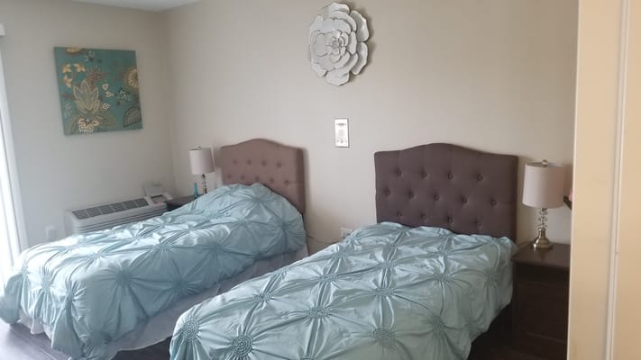 Cozy twin bedroom setup with decorative wall art