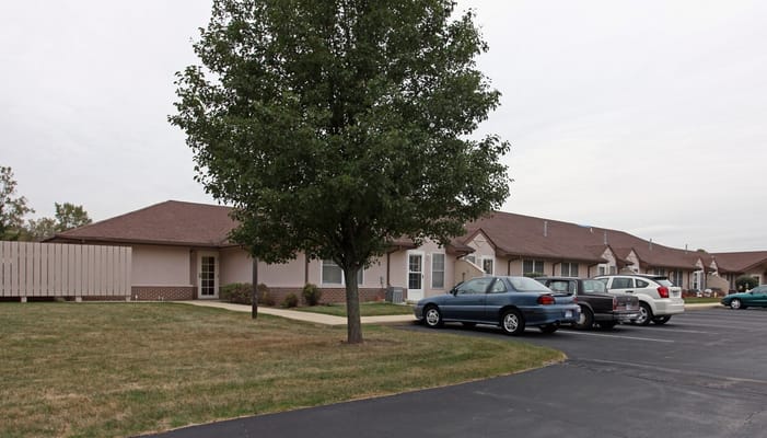 Exterior view of Luther Haus with parking spaces and a tree