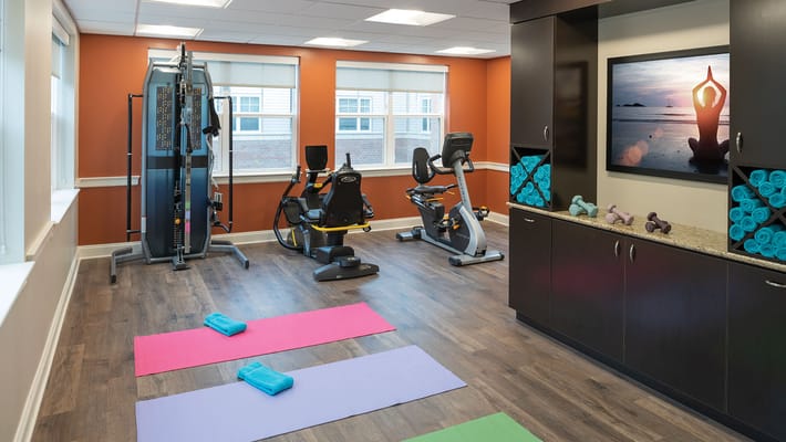 Fitness room with exercise equipment and mats