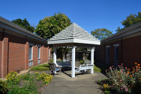 Outdoor sitting area with a gazebo and flowers