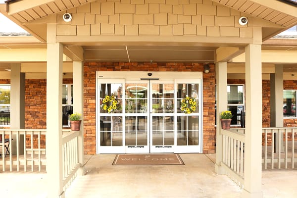 Entrance of a senior living facility with welcoming decorations