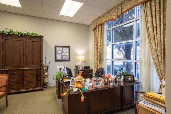 Cozy office space with personal touches and plants