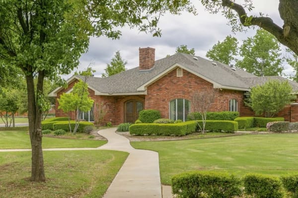 Exterior view of a senior living facility with landscaping