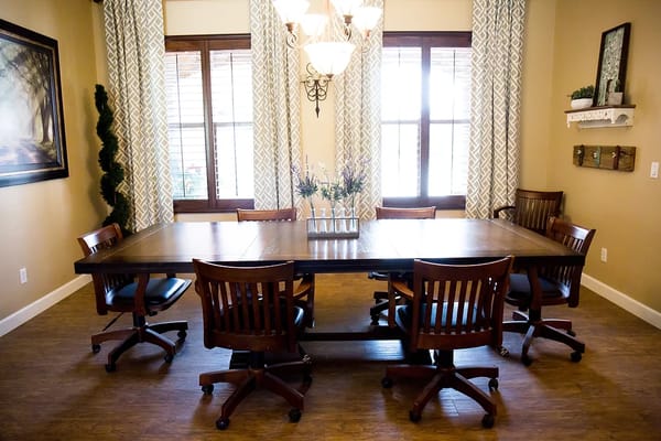 Bright common area with a large table and chairs