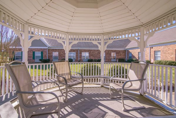 Outdoor gazebo with seating and view of building