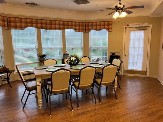 Bright dining area with a large table and chairs.