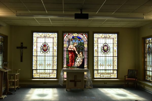 Interior view of a chapel with stained glass windows