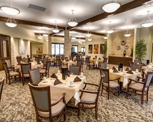 Spacious dining room with tables set for meals.