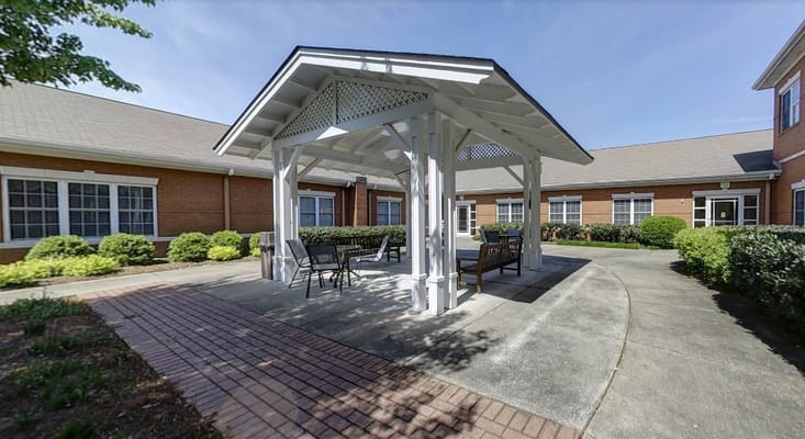 Outdoor seating area with a gazebo in a garden