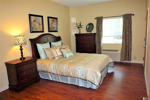 Cozy bedroom with a bed and artwork on the walls