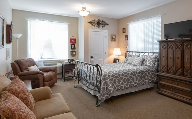 Cozy private resident room with bed and seating area