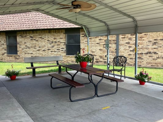 Outdoor seating area with tables and chairs