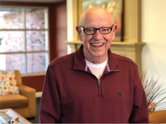 Smiling senior man in a living room setting