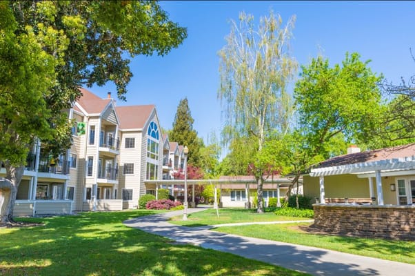 Beautiful exterior view of the assisted living facility with gardens
