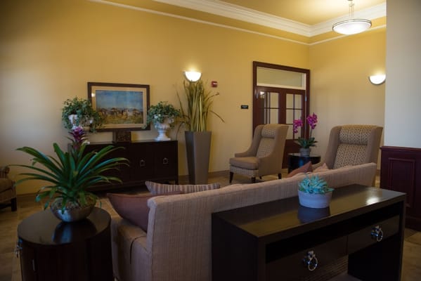 Comfortable seating area in the lobby with plants and artwork