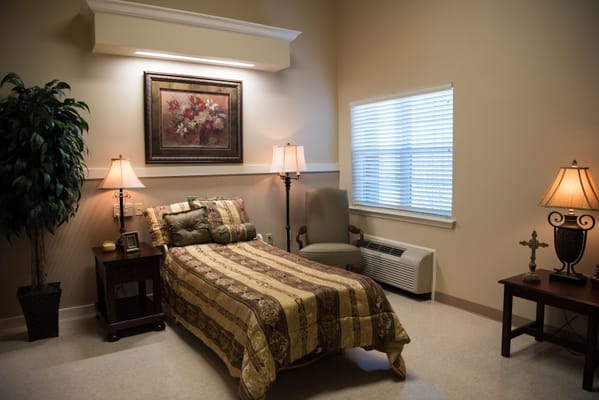 Cozy bedroom with a bed, chairs, and decorative lighting