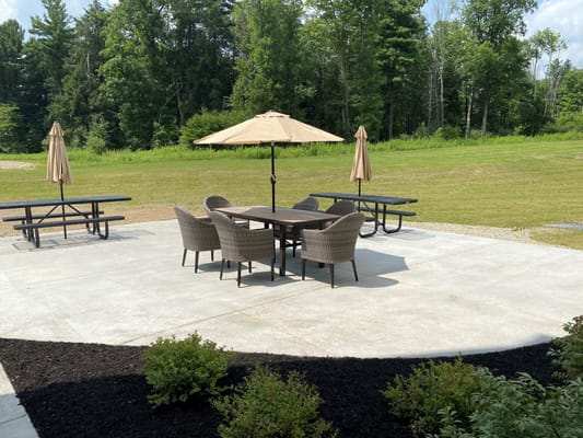 Outdoor seating area with umbrellas in a landscaped space