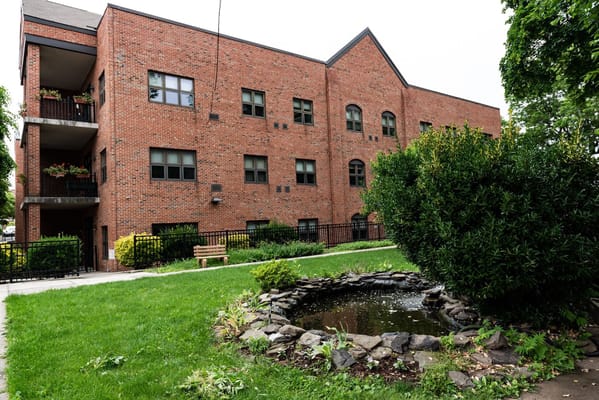 Exterior view of a senior living facility with landscaped garden