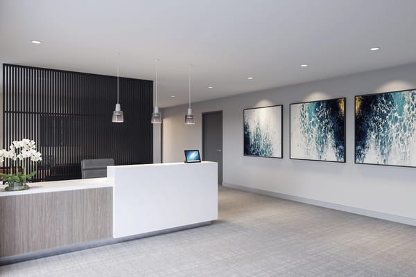 Modern reception desk with artwork on the walls.