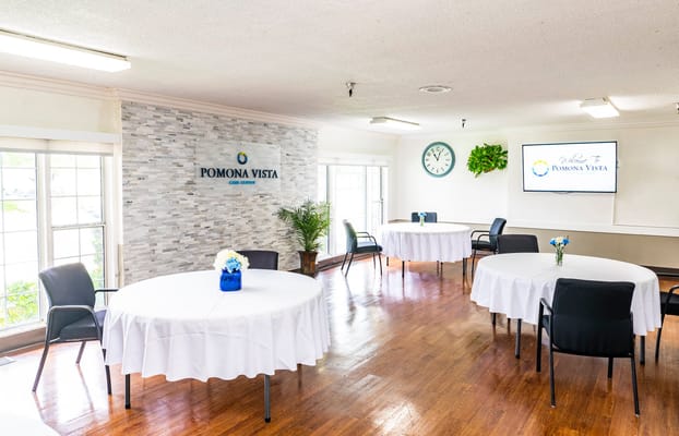 Common area with tables and chairs set up for an event