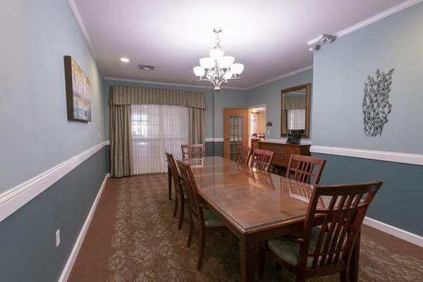 Spacious dining room with a large wooden table and chairs