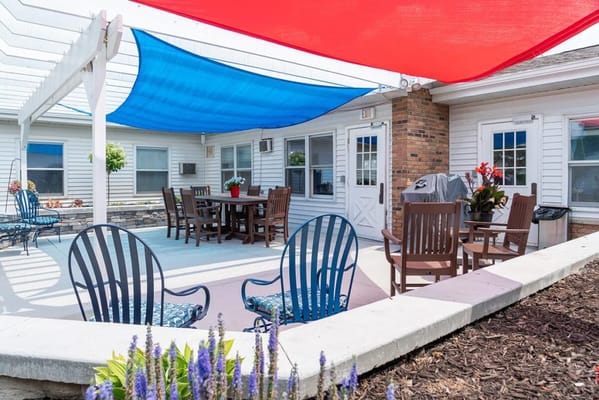 Seating area with colorful shade canopies at Prestige Center