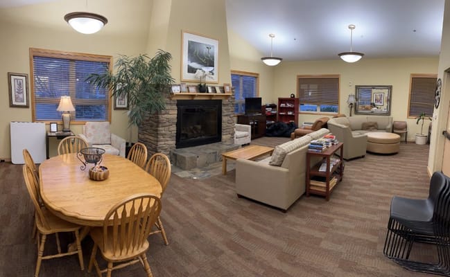 A spacious living room with comfortable seating and a dining table.