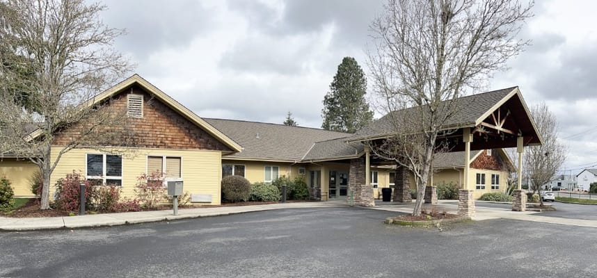 Exterior view of Ray Hickey Hospice House with a landscaped entrance
